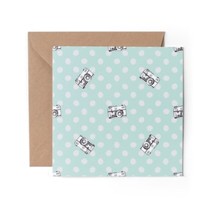 May include: A light blue card with a white polka dot pattern and a repeating image of a vintage camera.