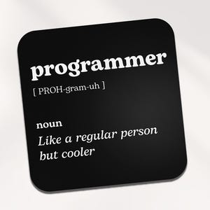 Op de afbeelding: Zwarte en witte onderzetter met het woord "programmeur" in vetgedrukte witte letters en een definitie van het woord eronder. De definitie luidt: "[PROH-gram-uh] zelfstandig naamwoord Net als een gewoon persoon, maar cooler."