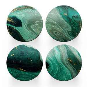 May include: Four round coasters featuring a green and gold marbled design. The coasters have a swirling pattern of green and gold, resembling natural stone.