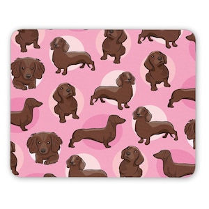 May include: A pink background with a repeating pattern of brown dachshund dogs in various poses. The dogs are surrounded by white polka dots.