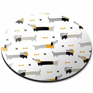 May include: White round mouse mat with a repeating pattern of black, grey, and yellow dachshunds with bone-shaped accents.
