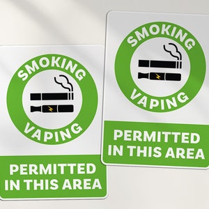 May include: Two white signs with green circles and the words "Smoking Vaping Permitted in this area". The circles contain black and white illustrations of a cigarette and a vape.