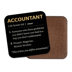 May include: A black square coaster with the word "ACCOUNTANT" in gold. The definition of accountant is printed in white, including the pronunciation and a humorous description. A brown cork coaster is behind it.