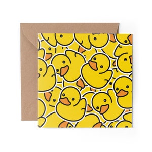 May include: A yellow greeting card featuring a pattern of yellow rubber ducks. The ducks are all facing different directions and have black eyes and orange beaks.