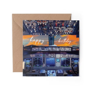 May include: A birthday card featuring a cockpit view of an aeroplane with a sunset in the background. The card reads "happy birthday".