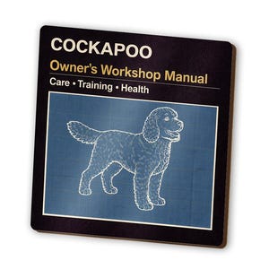 May include: A black square Cockapoo Owner's Workshop Manual. The manual features a blueprint-style illustration of a Cockapoo dog. The manual's title is in white, with the words "Care, Training, Health" below.