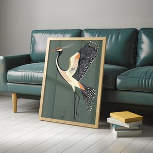 May include: A framed print of a stylized illustration of a crane with black, white, orange, and green colors on a green background.