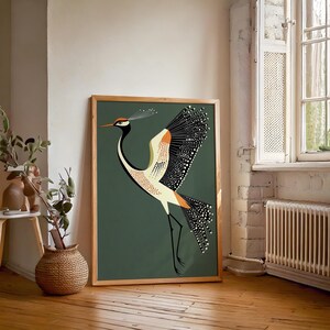 May include: A framed print of a stylized illustration of a crane with black, white, orange, and yellow markings on a dark green background.
