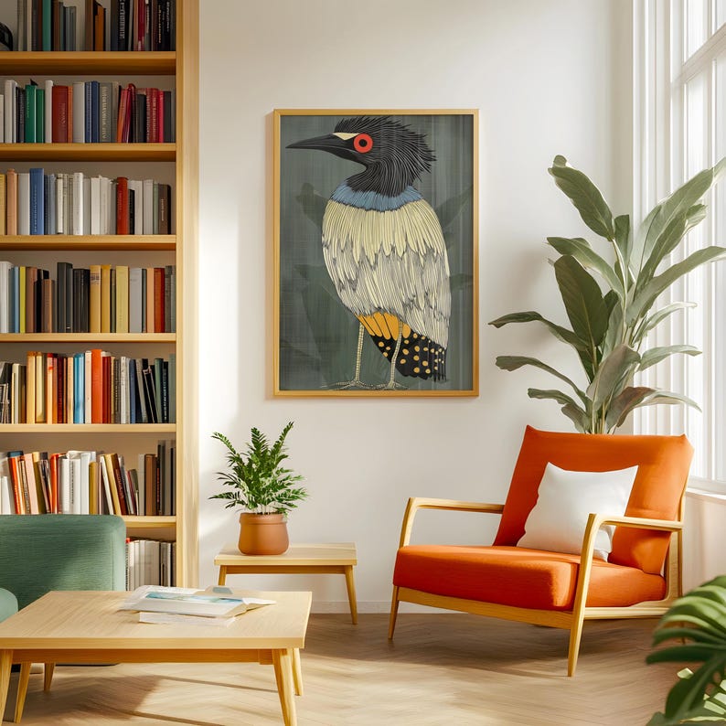 May include: A framed illustration of a bird with a black head, yellow and white feathers, and red eyes. The bird is standing on a branch with green leaves. The background is a dark green color.
