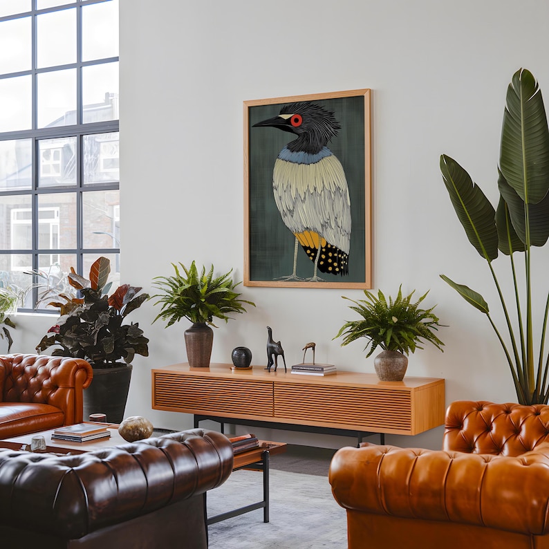 May include: A framed illustration of a colorful bird with a black head, red eyes, and yellow and black markings on its body. The bird is standing on a green background.