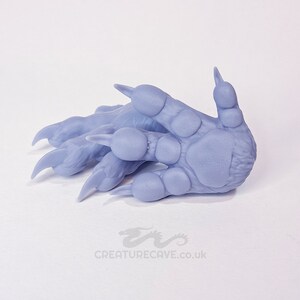 May include: A pair of light purple, 3D printed, detailed, realistic-looking animal paws with claws.