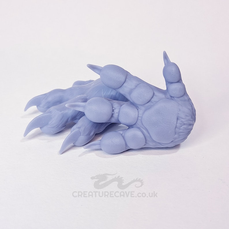 May include: A pair of light purple, 3D printed, detailed, realistic-looking animal paws with claws.
