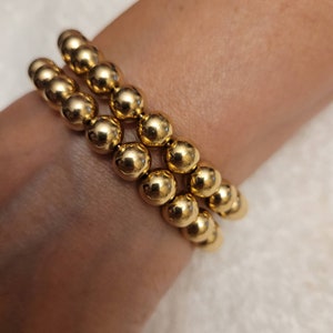 Genuine Brass Bangles with two ball dangles 2 for 24.99, 3 for 35.99.