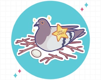 May include: A sticker featuring a cartoon pigeon sitting in a nest made of brown twigs next to a single white egg. The pigeon has a yellow star-shaped badge pinned to its chest with the text YOU TRIED! written in brown letters on the star.
