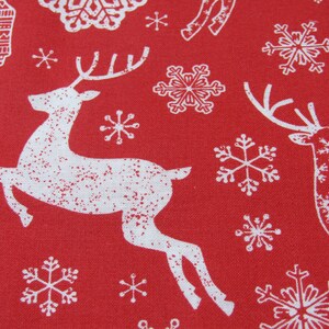May include: Red fabric with a repeating pattern of white reindeer and snowflakes. The reindeer are depicted in a running pose, and the snowflakes vary in design. This festive fabric is suitable for holiday-themed crafts and decorations.