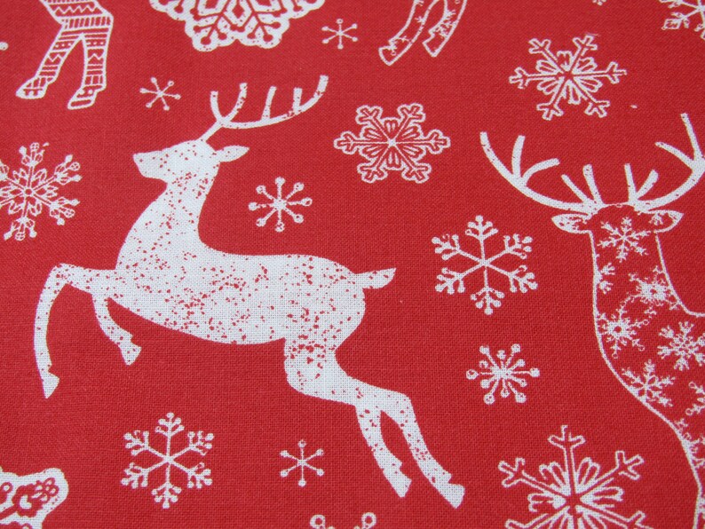 May include: Red fabric with a repeating pattern of white reindeer and snowflakes. The reindeer are depicted in a running pose, and the snowflakes vary in design. This festive fabric is suitable for holiday-themed crafts and decorations.
