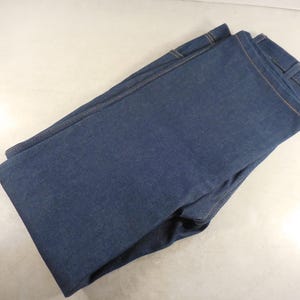 May include: A pair of folded blue denim jeans.