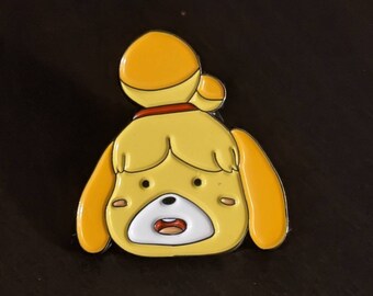 May include: A yellow enamel pin featuring a cartoon character with a surprised expression. The character has a yellow body, white eyes, a red mouth, and a brown headband. The character's ears are yellow and floppy.