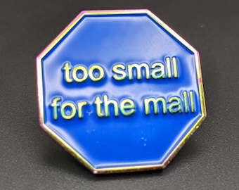 May include: A blue octagonal stop sign with a gold border and the text "too small for the mall" in yellow.