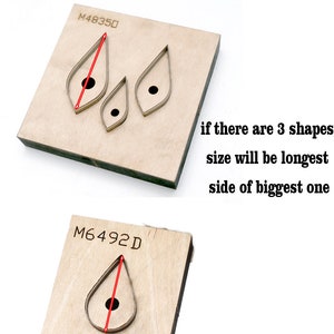 May include: Two pieces of wood with different shapes cut out of them. The top piece has three leaf shapes cut out, and the bottom piece has one teardrop shape cut out. The text "M48350" and "M6492D" is printed on the wood. The text "Please Note Size in option is for longest side" is printed above the wood pieces. The text "if there are 3 shapes size will be longest side of biggest one" is printed below the wood pieces.