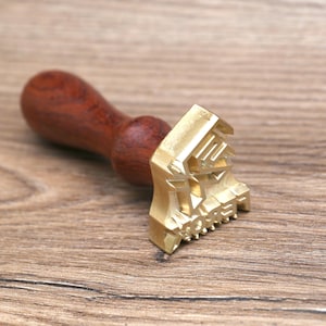 May include: A wooden handled brass stamp with the word "MONEY" embossed on the face.