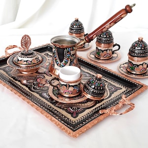 May include: A traditional Turkish coffee set featuring a copper tray, teapot, cups, and sugar bowl. The set is decorated with intricate hand-painted floral designs in vibrant colours.