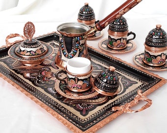 May include: A traditional Turkish coffee set with a copper tray, teapot, cups, and sugar bowl. The set is decorated with intricate hand-painted floral designs in vibrant colors.