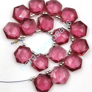 May include: A strand of faceted pink quartz beads, each bead is a hexagonal shape with a faceted finish. The beads are strung on a silver wire with silver spacer beads.