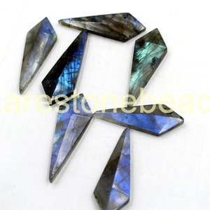 May include: Six iridescent blue and grey labradorite gemstone points, each with a faceted, diamond-shaped design.