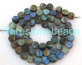 May include: A strand of round, flat, iridescent labradorite beads in shades of green, blue, and grey. The beads are approximately 10mm in diameter and have a smooth, polished finish.