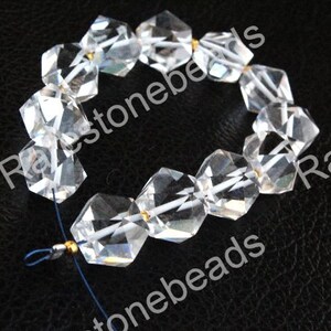 May include: A strand of clear faceted crystal beads with gold spacers. The beads are strung on a blue cord.