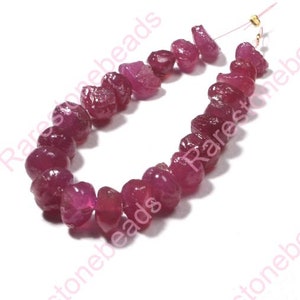 May include: A strand of ruby gemstone beads, each bead is faceted and has a deep red color. The beads are strung on a thin wire and are ready to be used for jewelry making.