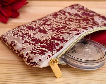 Small oriental makeup bag made of Moroccan fabric in wine red with abstract patterns