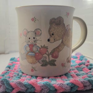 A coffee cup sitting on one of the potholders