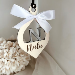 Christmas ball with personalized first name and white satin ribbon