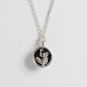 Sterling silver Labyrinth Worm in a Cup necklace with oxidised finish, shown on white background
