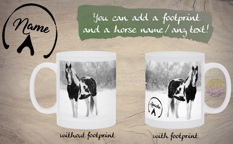 May include: White ceramic mug with a black and white photo of a horse in a snowy field. The mug has the text "Apache" and a horseshoe footprint on the side. The mug is shown next to a similar mug without the text or footprint.