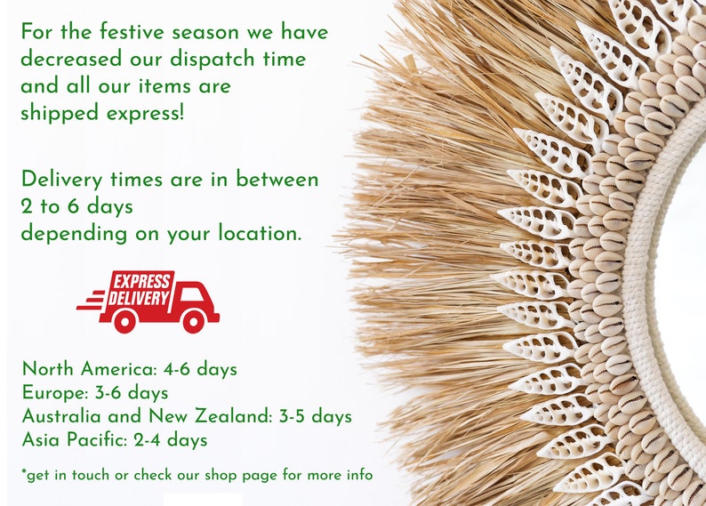 May include: A close-up of a natural woven wreath with white seashells. The wreath is decorated with a variety of seashells, including cowrie shells and scallop shells. The wreath is surrounded by a fringe of natural fibers. The text "EXPRESS DELIVERY" is visible in the lower left corner of the image. The text "Delivery times are in between 2 to 6 days depending on your location." is visible in the upper left corner of the image. The text "North America: 4-6 days, Europe: 3-6 days, Australia and New Zealand: 3-5 days, Asia Pacific: 2-4 days" is visible in the lower left corner of the image.