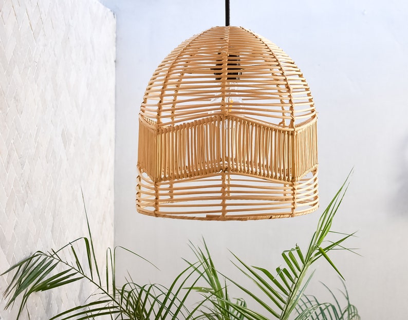 May include: A natural woven pendant light fixture with a dome shape and a light brown color. The light fixture is made of woven rattan and has a geometric pattern.
