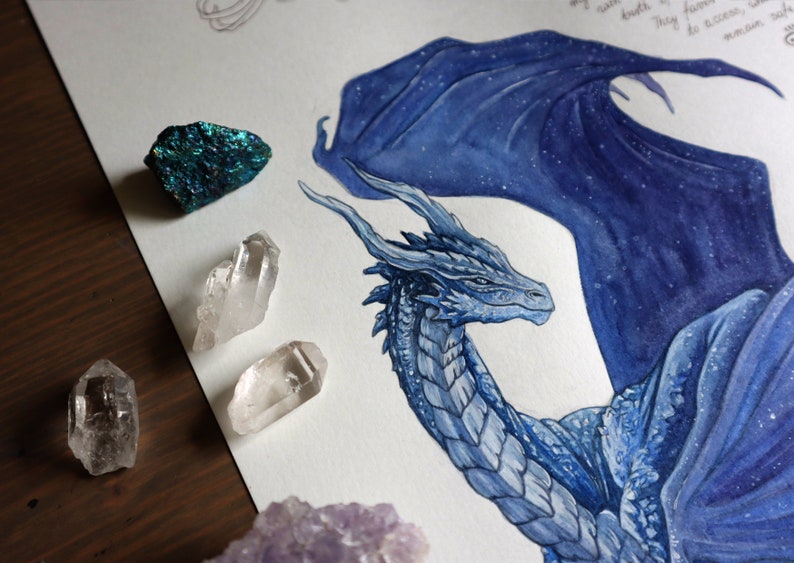 May include: A watercolor painting of a blue dragon with a starry sky pattern on its wings. The dragon's head is turned to the side, and its eyes are closed. The painting is surrounded by crystals.