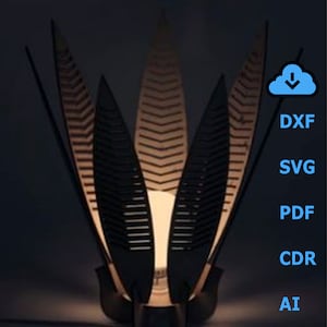 May include: A black wooden lamp with a geometric design resembling leaves. The lamp has a warm light emanating from the center. The image includes a download icon and the file types DXF, SVG, PDF, CDR, and AI.