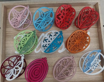 May include: A collection of 10 wooden ornaments with intricate laser-cut designs. The ornaments are in various colors, including pink, blue, green, red, orange, and brown. Each ornament features a different design, such as snowflakes, stars, and geometric patterns.