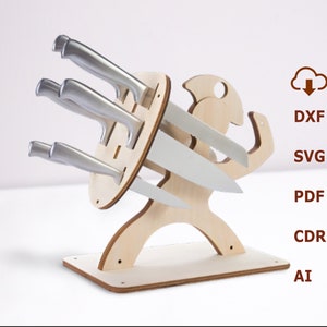May include: A wooden knife holder shaped like a person holding a sword. The holder has four slots for knives and a base for stability. The holder is made of light wood and has a natural finish.
