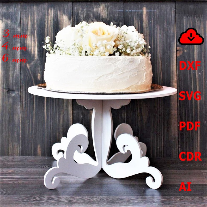 May include: White cake stand with a white cake decorated with white flowers. The stand has a round top and three legs with a decorative design. The cake stand is 3 inches, 4 inches, and 6 inches in diameter.