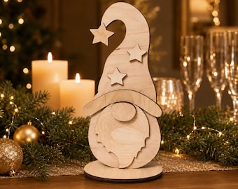 May include: A light-colored wooden gnome figurine featuring a tall, curved hat adorned with three star-shaped cutouts. The gnome has a round nose and a textured beard, all mounted on a circular base. The natural wood grain is visible throughout.