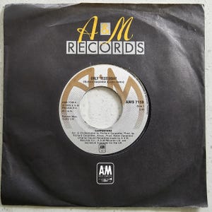 May include: A vintage 45 RPM vinyl record for the song "Only Yesterday" by The Carpenters, in a black paper sleeve. The record label displays the A&M Records logo and song information.