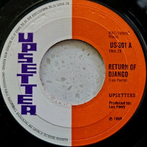 May include: A white and orange vinyl record with the text "US-301 A" and "Return of Django (Lee Perry)" on the label. The record is by the band "Upsetters" and was produced by Lee Perry in 1959.