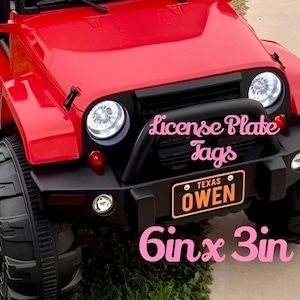 May include: Red toy jeep with black wheels and a license plate that says "Texas Owen". The jeep has a black bumper with a white text overlay that says "License Plate Tags 6in x 3in".