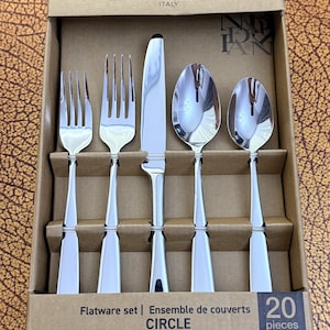 May include: A 20-piece Brandani Italy flatware set in a cardboard box. The set includes a small fork, a large fork, a dinner knife, a large spoon, and a small spoon, all made of polished silver-tone metal with a smooth, tapered handle design.
