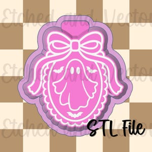 May include: A pink and light purple cookie cutter featuring an oval frame with a scalloped edge, a large bow at the top, a central ghost figure, and small bat silhouettes. The design includes white outlines and the text STL File in the bottom corner.